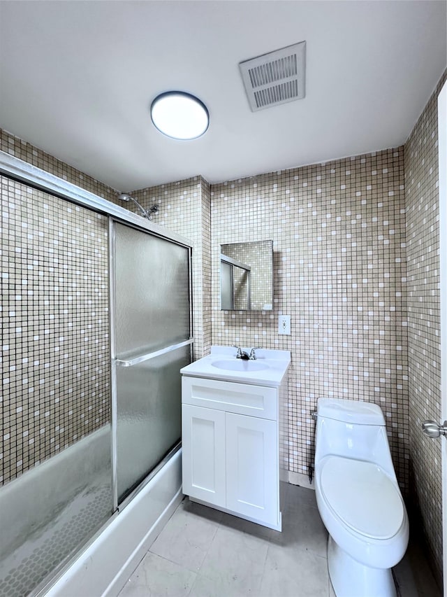 43-18 Robinson Unit 7C, Flushing, NY 11355 - bathroom with enclosed tub / shower combo, vanity, tile patterned floors, and tile walls