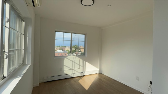 43-18 Robinson Unit 7C, Flushing, NY 11355 - unfurnished room with a baseboard radiator and wood finished floors