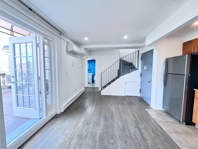 43-18 Robinson Unit 7C, Flushing, NY 11355 - interior space with freestanding refrigerator, baseboard heating, a wall unit AC, light wood-type flooring, and recessed lighting