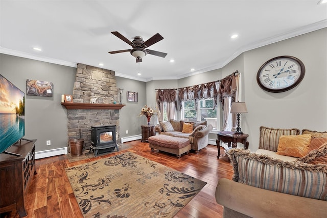 2300 State Route 207, Rock Tavern, NY 12575 - living area featuring a ceiling fan, a baseboard heating unit, a wood stove, crown molding, and hardwood / wood-style flooring