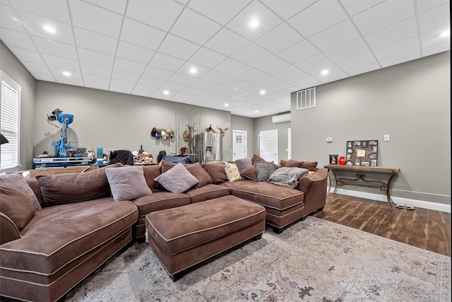 2300 State Route 207, Rock Tavern, NY 12575 - living area with dark wood finished floors, a wall mounted AC, recessed lighting, and a paneled ceiling