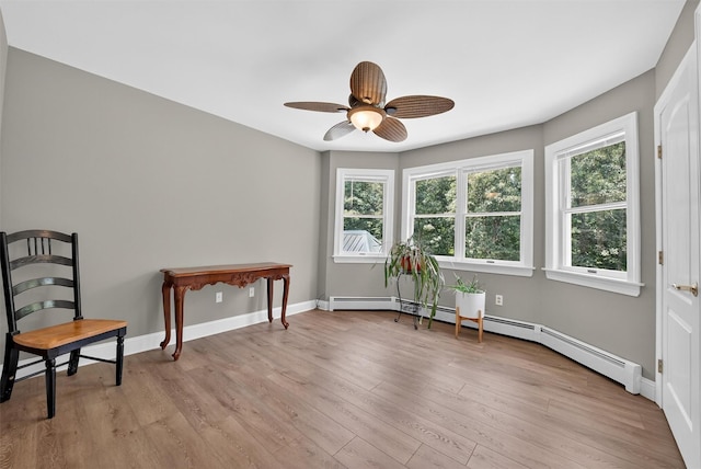 2300 State Route 207, Rock Tavern, NY 12575 - living area featuring light wood-type flooring, ceiling fan, and a baseboard heating unit