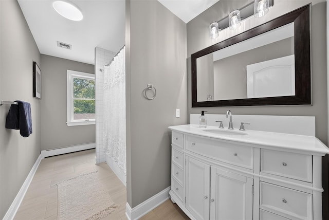 2300 State Route 207, Rock Tavern, NY 12575 - full bathroom with baseboard heating, vanity, wood finished floors, and a shower with curtain