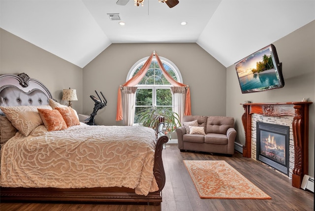 2300 State Route 207, Rock Tavern, NY 12575 - bedroom with dark wood-style floors, vaulted ceiling, a ceiling fan, a tile fireplace, and a baseboard heating unit