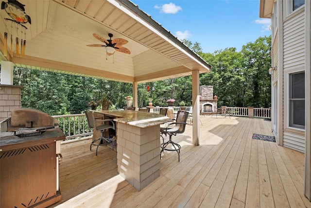 2300 State Route 207, Rock Tavern, NY 12575 - deck with a lit fireplace, a gazebo, grilling area, ceiling fan, and view of wooded area