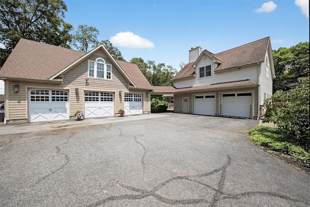 2300 State Route 207, Rock Tavern, NY 12575 - view of front of property featuring a chimney, a shingled roof, driveway, and a garage