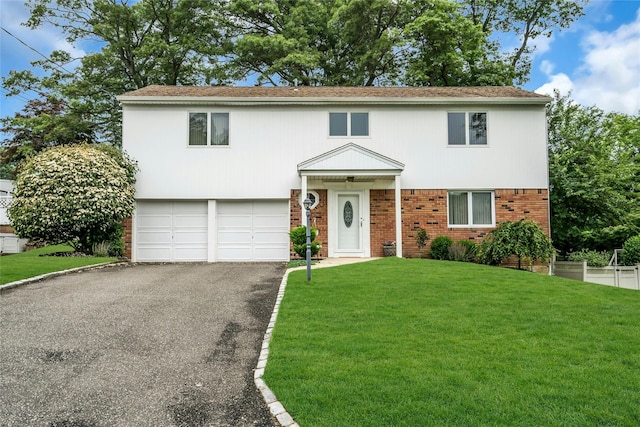 185 Harvard Dr, Plainview, NY 11803 - view of front of home featuring brick siding, a garage, asphalt driveway, and a front lawn