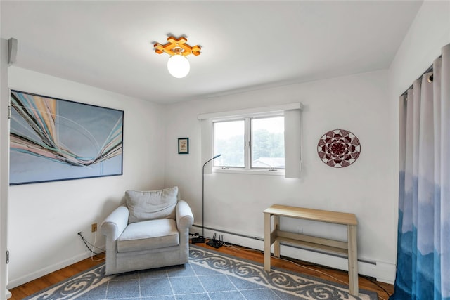 185 Harvard Dr, Plainview, NY 11803 - sitting room with wood finished floors and a baseboard heating unit