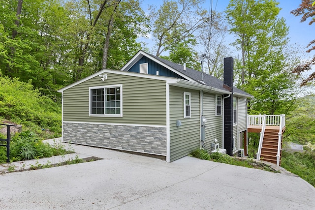 13 Ripley Rd, Patterson, NY 12563 - view of front of home featuring stairs, a chimney, a deck, a patio, and stone siding