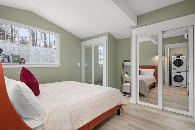 13 Ripley Rd, Patterson, NY 12563 - bedroom with stacked washing machine and dryer, lofted ceiling, light wood finished floors, and a closet