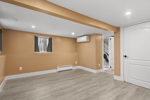 13 Ripley Rd, Patterson, NY 12563 - below grade area featuring a wall mounted AC, a baseboard heating unit, light wood-type flooring, and recessed lighting