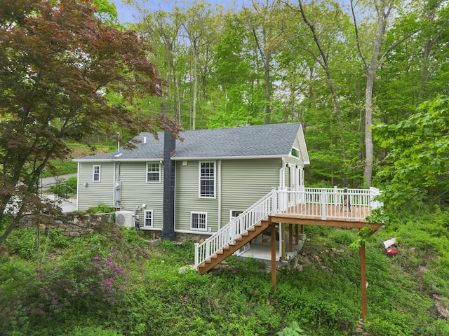 13 Ripley Rd, Patterson, NY 12563 - back of house featuring stairs, a deck, roof with shingles, and a chimney