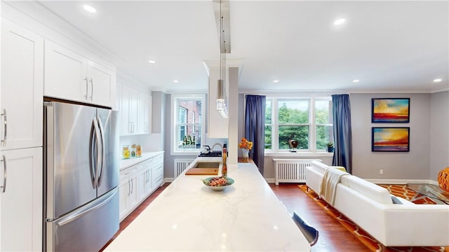 1133 Midland Ave Unit 4C, Bronxville, NY 10708 - kitchen with freestanding refrigerator, radiator heating unit, open floor plan, ornamental molding, and white cabinets