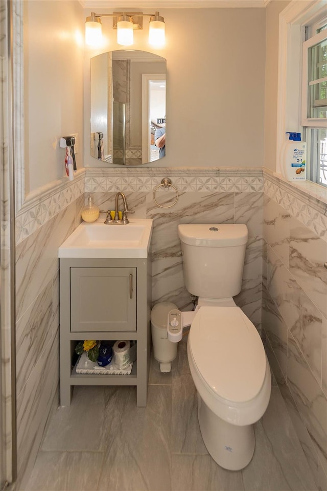 65 Berkshire Trl, Smallwood, NY 12720 - bathroom featuring tile walls, a wainscoted wall, vanity, marble finish floors, and crown molding