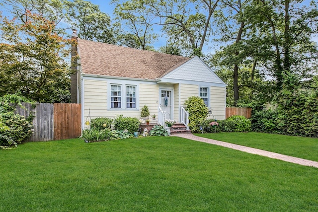15 Robbins Ave, Islip, NY 11751 - view of front of house with a shingled roof and a chimney