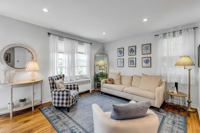 15 Robbins Ave, Islip, NY 11751 - living room with radiator heating unit, wood finished floors, and recessed lighting