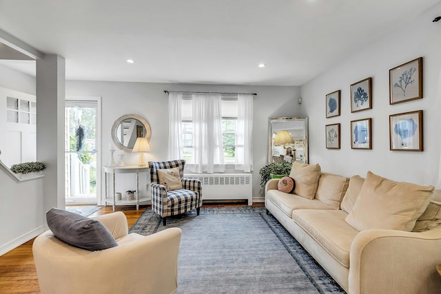 15 Robbins Ave, Islip, NY 11751 - living room featuring radiator, plenty of natural light, wood finished floors, and recessed lighting