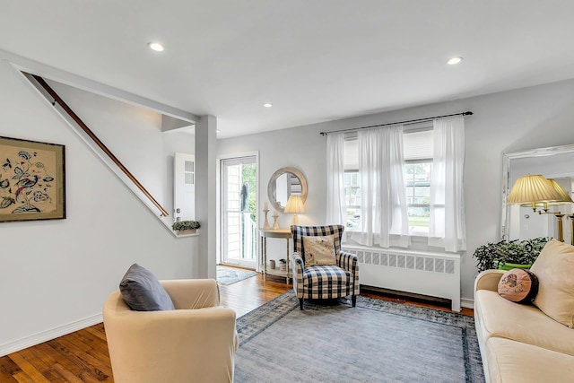 15 Robbins Ave, Islip, NY 11751 - living area with radiator, wood finished floors, recessed lighting, and stairway