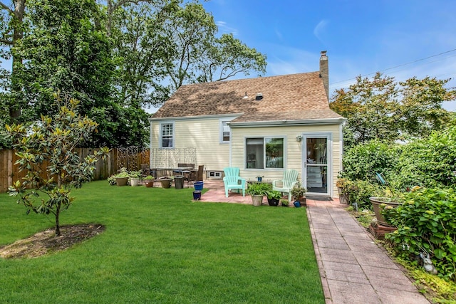 15 Robbins Ave, Islip, NY 11751 - back of house featuring a chimney, roof with shingles, and a patio
