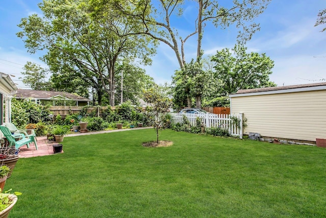 15 Robbins Ave, Islip, NY 11751 - fenced backyard with a patio area