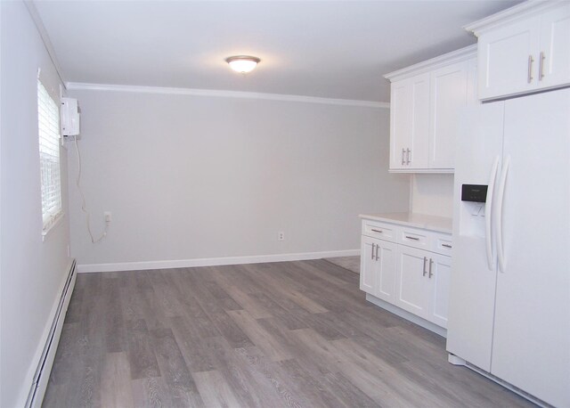 33 Roosevelt Ave, Selden, NY 11784 - kitchen featuring white fridge with ice dispenser, a baseboard radiator, ornamental molding, wood finished floors, and light countertops