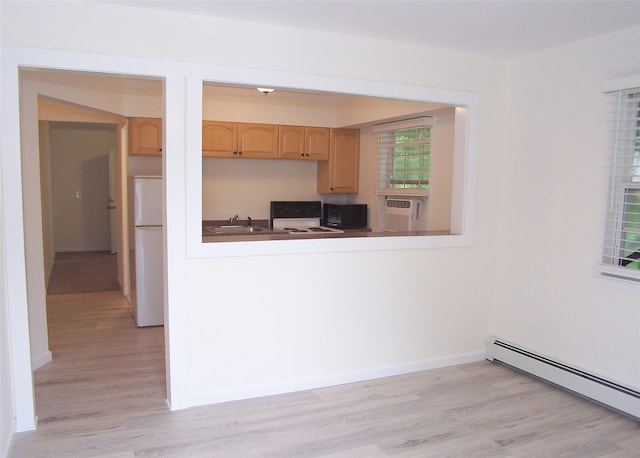 33 Roosevelt Ave, Selden, NY 11784 - kitchen featuring freestanding refrigerator, a baseboard radiator, light brown cabinets, and light wood finished floors