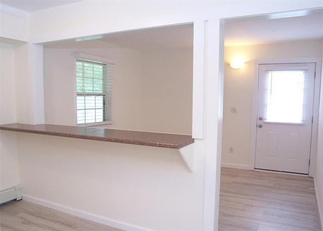 33 Roosevelt Ave, Selden, NY 11784 - foyer entrance with wood finished floors and a baseboard radiator