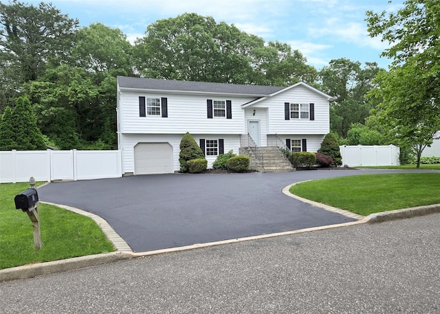 33 Roosevelt Ave, Selden, NY 11784 - split foyer home with asphalt driveway and an attached garage