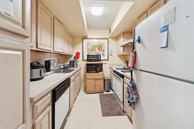 1901 Madison Ave Unit 105, New York Manhattan, NY 10035 - kitchen with white appliances, light brown cabinetry, a textured ceiling, light countertops, and under cabinet range hood