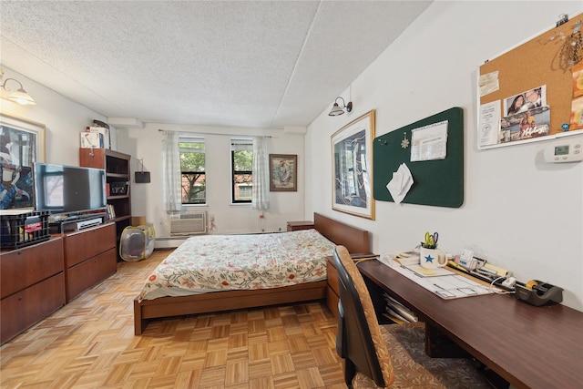 1901 Madison Ave Unit 105, New York Manhattan, NY 10035 - bedroom with a textured ceiling, cooling unit, and a baseboard radiator