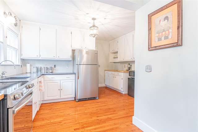 16 Beechwood Park, Poughkeepsie, NY 12601 - kitchen with appliances with stainless steel finishes, white cabinetry, light wood finished floors, and decorative backsplash