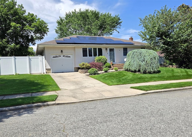 4 Bowman Ln, Commack, NY 11725 - view of front of home featuring roof mounted solar panels, an attached garage, a gate, and driveway