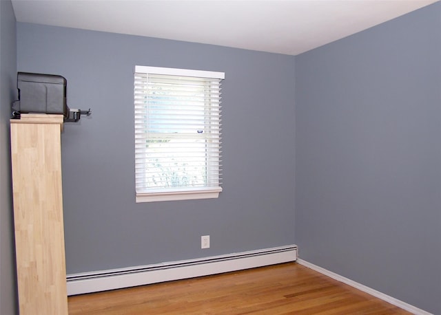 4 Bowman Ln, Commack, NY 11725 - unfurnished room with a baseboard radiator and wood finished floors