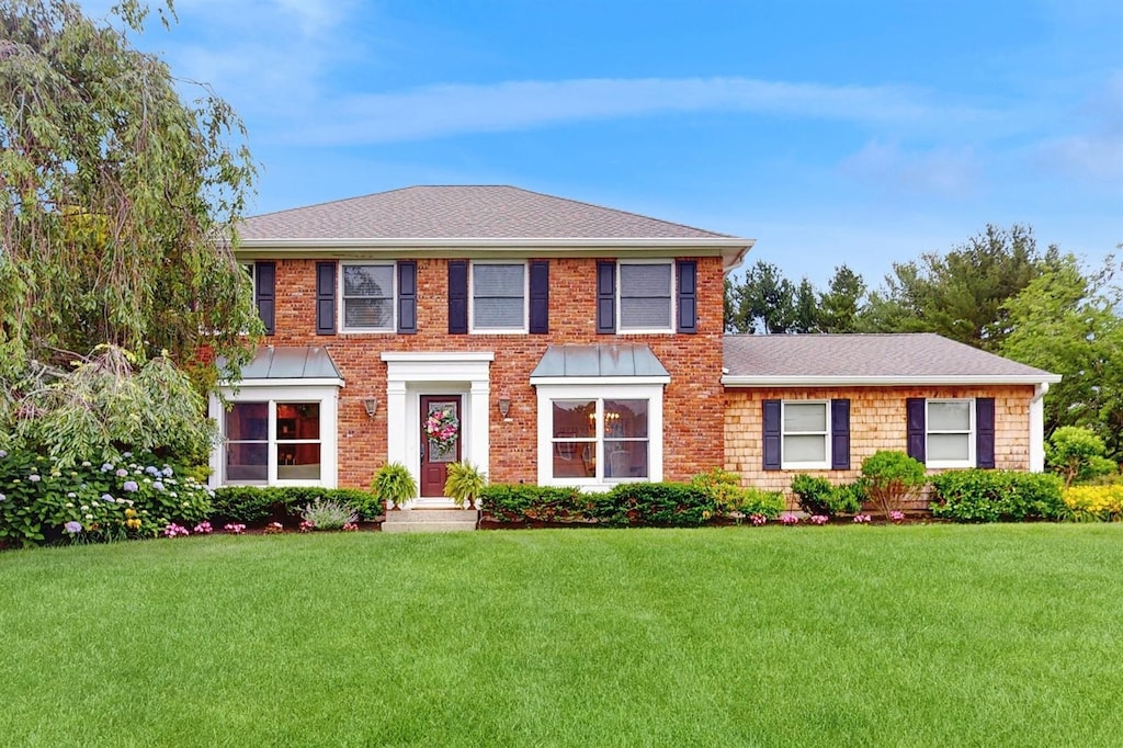 2 Lynbrook Ct, Huntington, NY 11743 - georgian-style home with a front lawn, a shingled roof, and brick siding