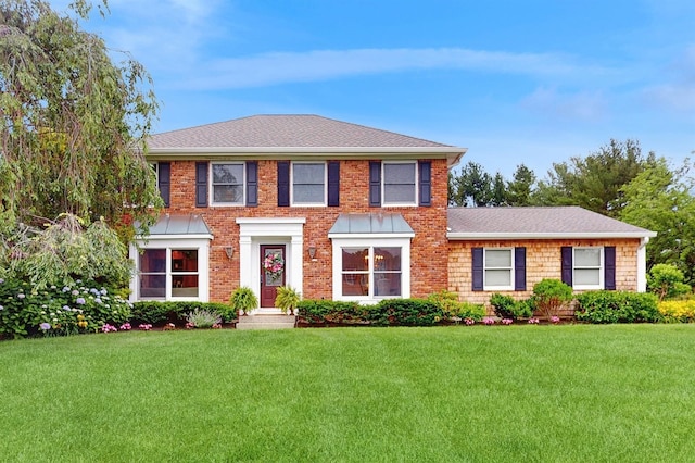 2 Lynbrook Ct, Huntington, NY 11743 - georgian-style home with a front lawn, a shingled roof, and brick siding