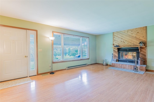 2136 Rte 55, Lagrangeville, NY 12540 - unfurnished living room featuring baseboard heating, wood finished floors, and a multi sided fireplace