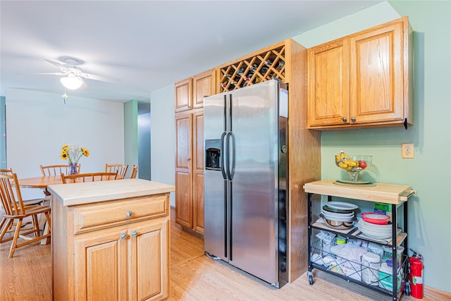 2136 Rte 55, Lagrangeville, NY 12540 - kitchen with stainless steel fridge, light wood-type flooring, a ceiling fan, light brown cabinets, and a kitchen island