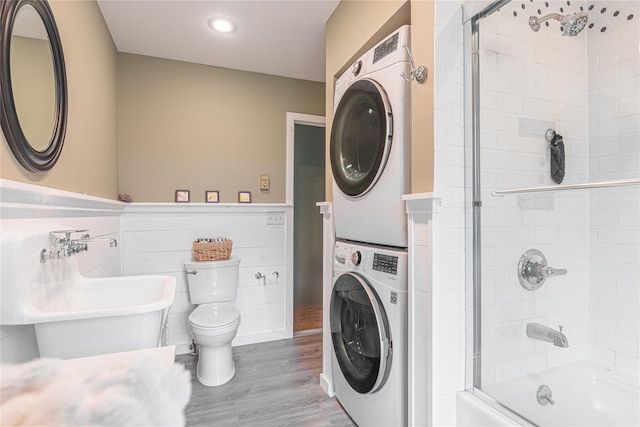 2136 Rte 55, Lagrangeville, NY 12540 - bathroom featuring stacked washer / dryer, wood finished floors, shower / bath combination with glass door, and recessed lighting