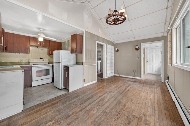 9 Mimosa St, Lake Peekskill, NY 10537 - kitchen featuring white appliances, a baseboard radiator, light countertops, light wood-type flooring, and lofted ceiling
