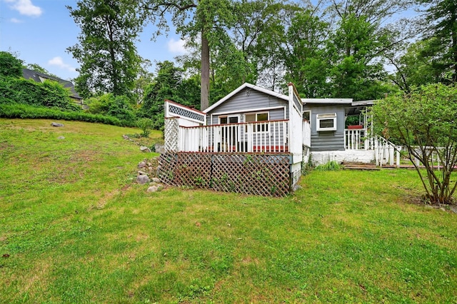 9 Mimosa St, Lake Peekskill, NY 10537 - rear view of house with a yard and a wooden deck