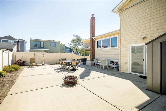 755 E Chester St, Long Beach, NY 11561 - fenced backyard featuring outdoor dining area, a patio, and an outdoor fire pit