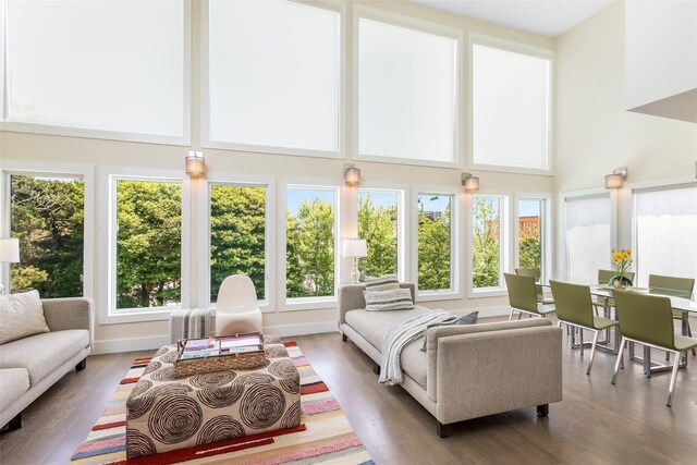172 Pine Walk, Fire Island Pines, NY 11782 - living room with healthy amount of natural light, a towering ceiling, and wood finished floors