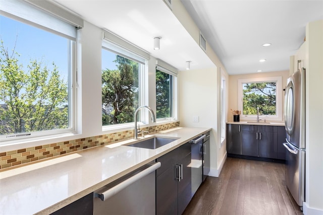 172 Pine Walk, Fire Island Pines, NY 11782 - kitchen with appliances with stainless steel finishes, dark wood-style floors, tasteful backsplash, plenty of natural light, and recessed lighting
