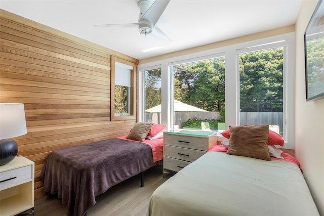 172 Pine Walk, Fire Island Pines, NY 11782 - bedroom with wooden walls, wood finished floors, and a ceiling fan