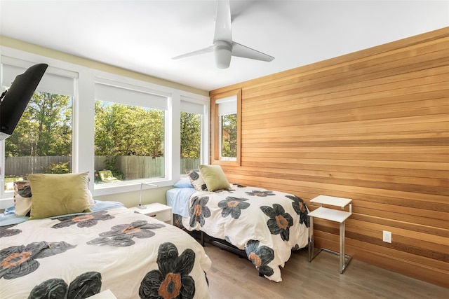 172 Pine Walk, Fire Island Pines, NY 11782 - bedroom featuring wooden walls, wood finished floors, and a ceiling fan