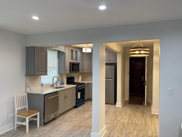 138-28 77th Unit 64C, Kew Garden Hills, NY 11367 - kitchen featuring stainless steel appliances, gray cabinetry, light countertops, light wood-style flooring, and recessed lighting
