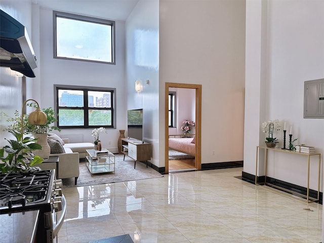 31-47 137th St Unit 4C, Flushing, NY 11354 - living area with a towering ceiling, electric panel, and marble tiled flooring