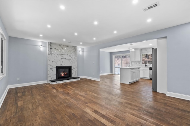 48 Lockwood Rd, South Salem, NY 10590 - unfurnished living room featuring dark wood-type flooring, recessed lighting, and a high end fireplace