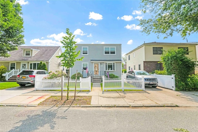 4911 168th St, Flushing, NY 11365 - multi unit property featuring driveway and a fenced front yard