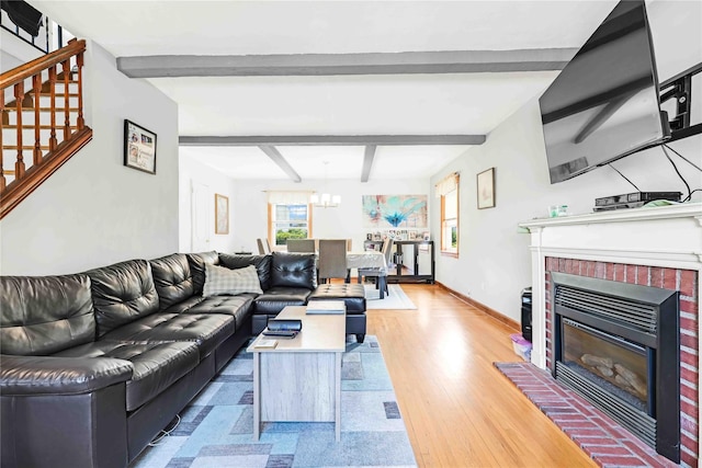 4911 168th St, Flushing, NY 11365 - living room featuring stairs, a brick fireplace, beamed ceiling, a chandelier, and wood finished floors